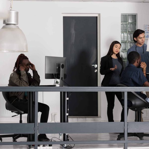 African american web developer brainstorming ideas for html script development, trying to create html code. It software developer working at database server in software office company