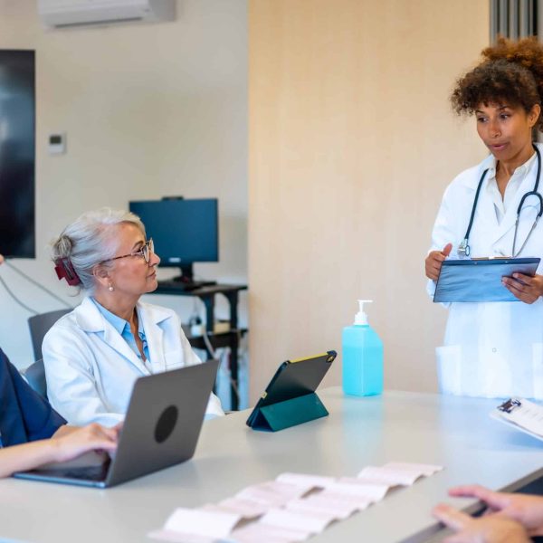 Doctors and nurses participating in a medical briefing, analyzing patient data and treatment plans in a modern hospital setting
