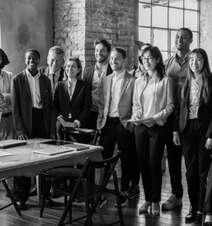 Team of businesspeople standing in coworking area working together
