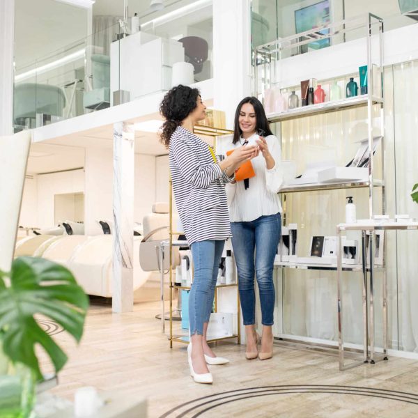 Talking. Two dark-haired women talking in the beauty shop
